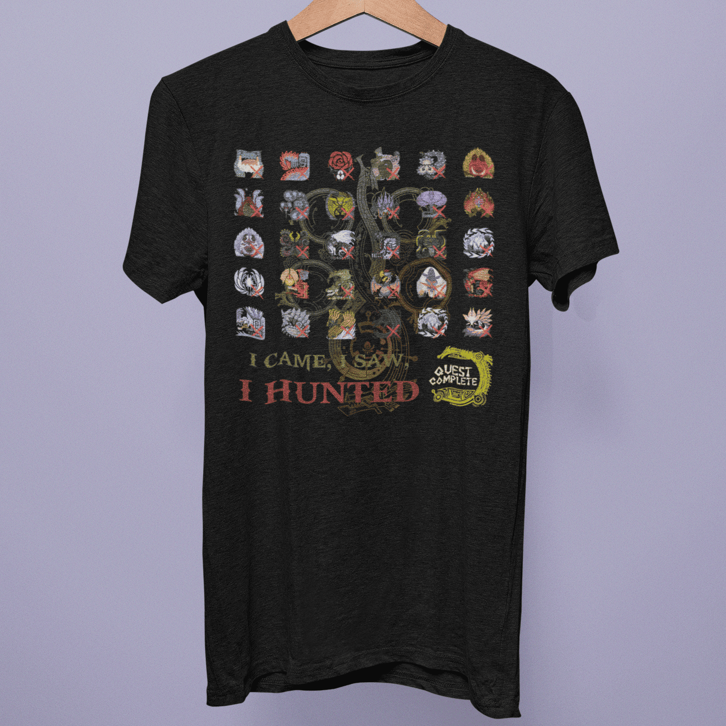Front view of the Monster Hunter Wilds Collection T-shirt on a hanger, showing monster icon checklist artwork with “I Came, I Saw, I Hunted” text on black fabric.