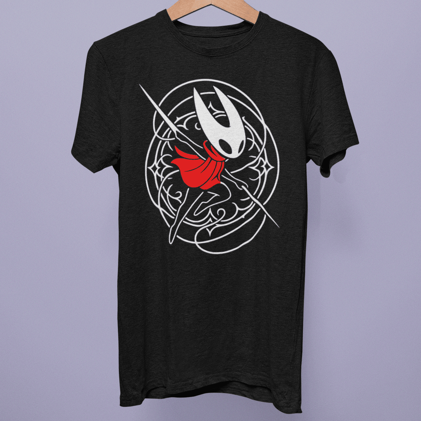 Front view of the Hollow Knight Silksong Collection T-shirt on a hanger, showing Hornet artwork with a red scarf on black fabric.
