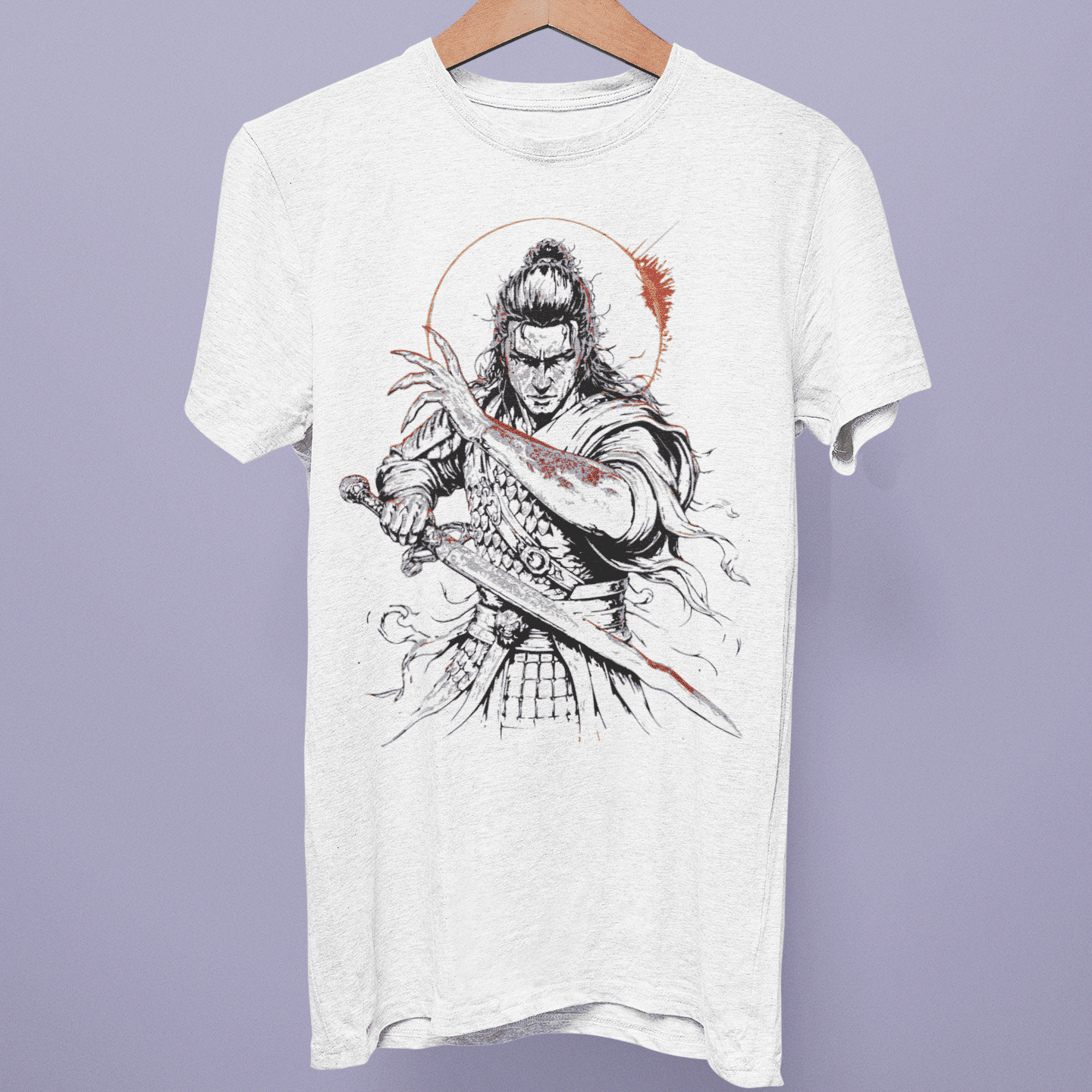 Front view of the Assassin’s Creed Shadows Collection T-shirt on a hanger, showing samurai sword artwork with red brush accents on white fabric.