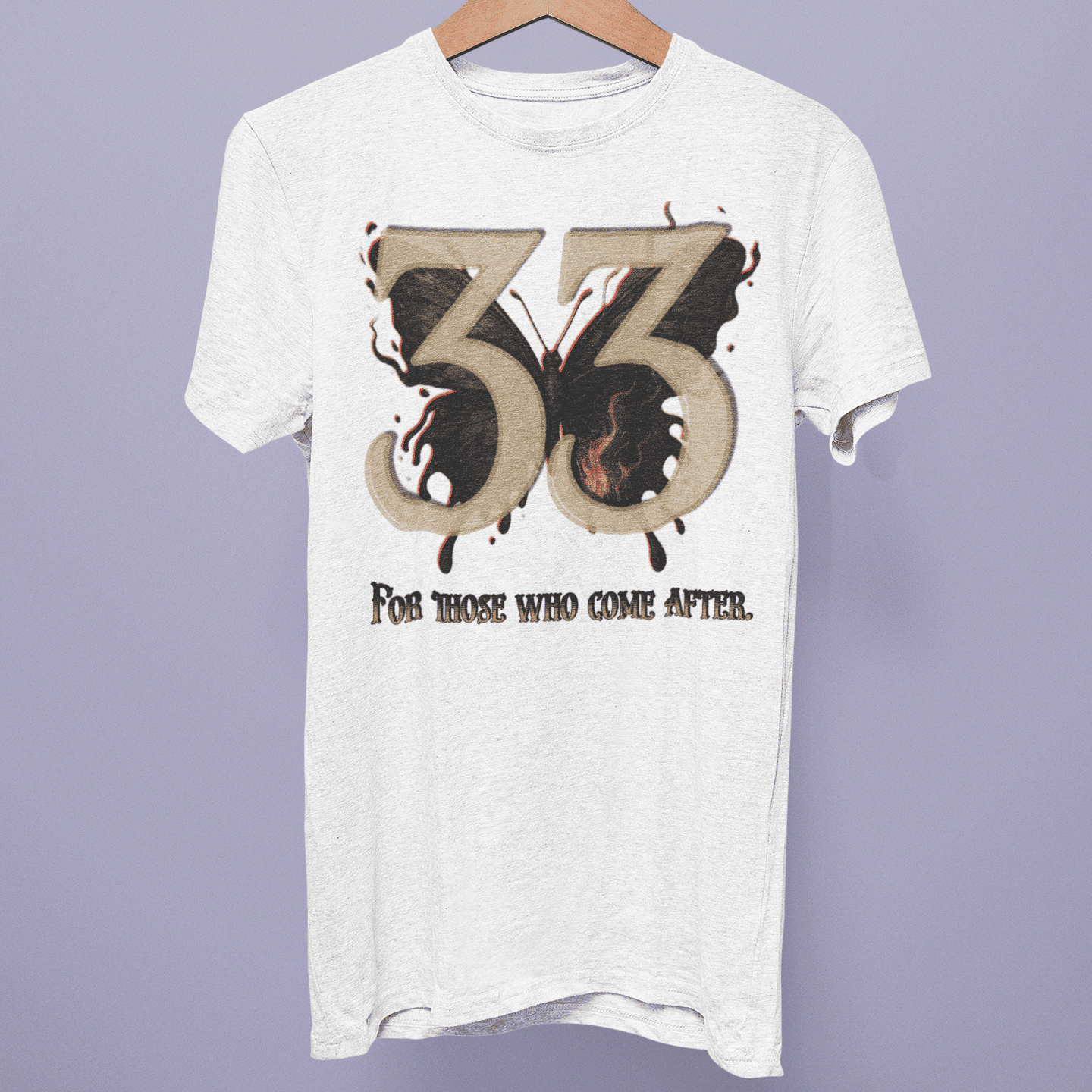 Front view of the Expedition 33 Collection T-shirt on a hanger, showing the 33 emblem and “For Those Who Come After” artwork on white fabric.