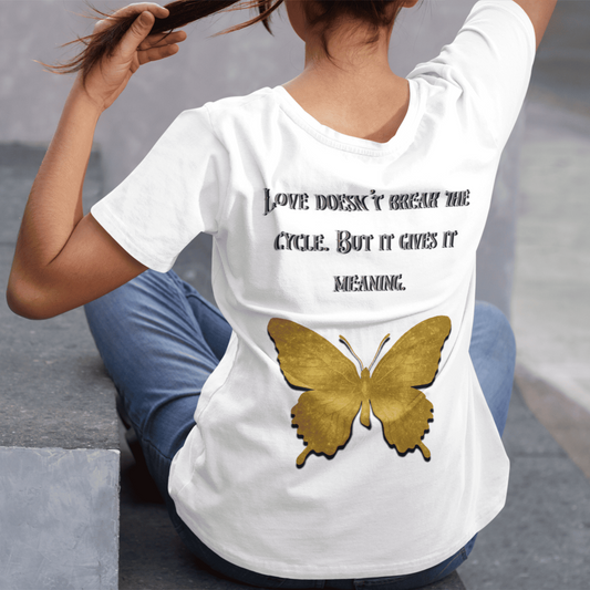 Person wearing a white t-shirt with a butterfly design and text, sitting on steps.