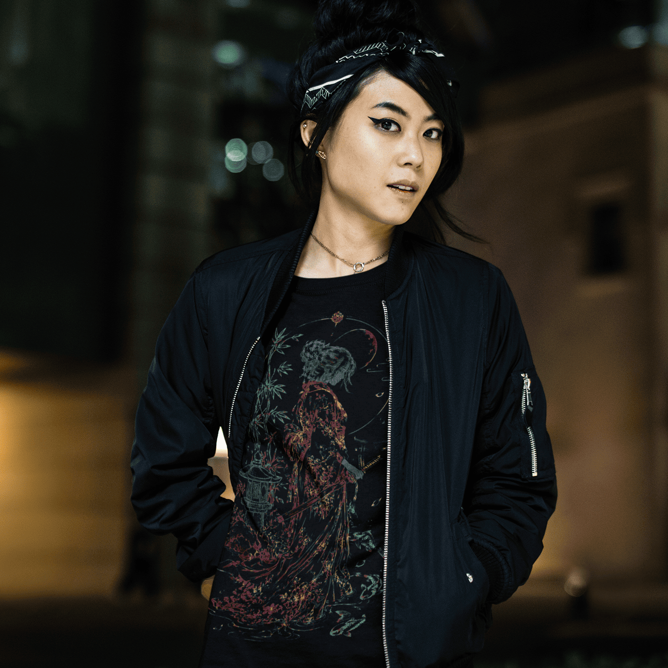 Female model in Female Samurai T-Shirt with detailed warrior artwork during a cinematic city night scene.