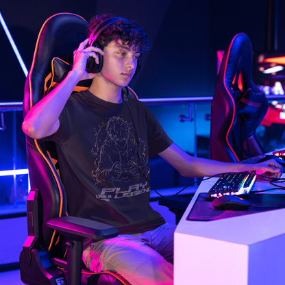 Lifestyle view of Play Like a Legend Gamer T-Shirt – Anime Player Mode worn at a neon gaming setup