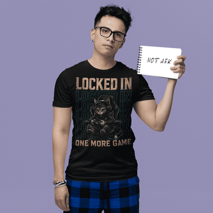 Male gamer holding a sign in Locked In Cat Gamer T-Shirt with one more game artwork on a purple studio background.