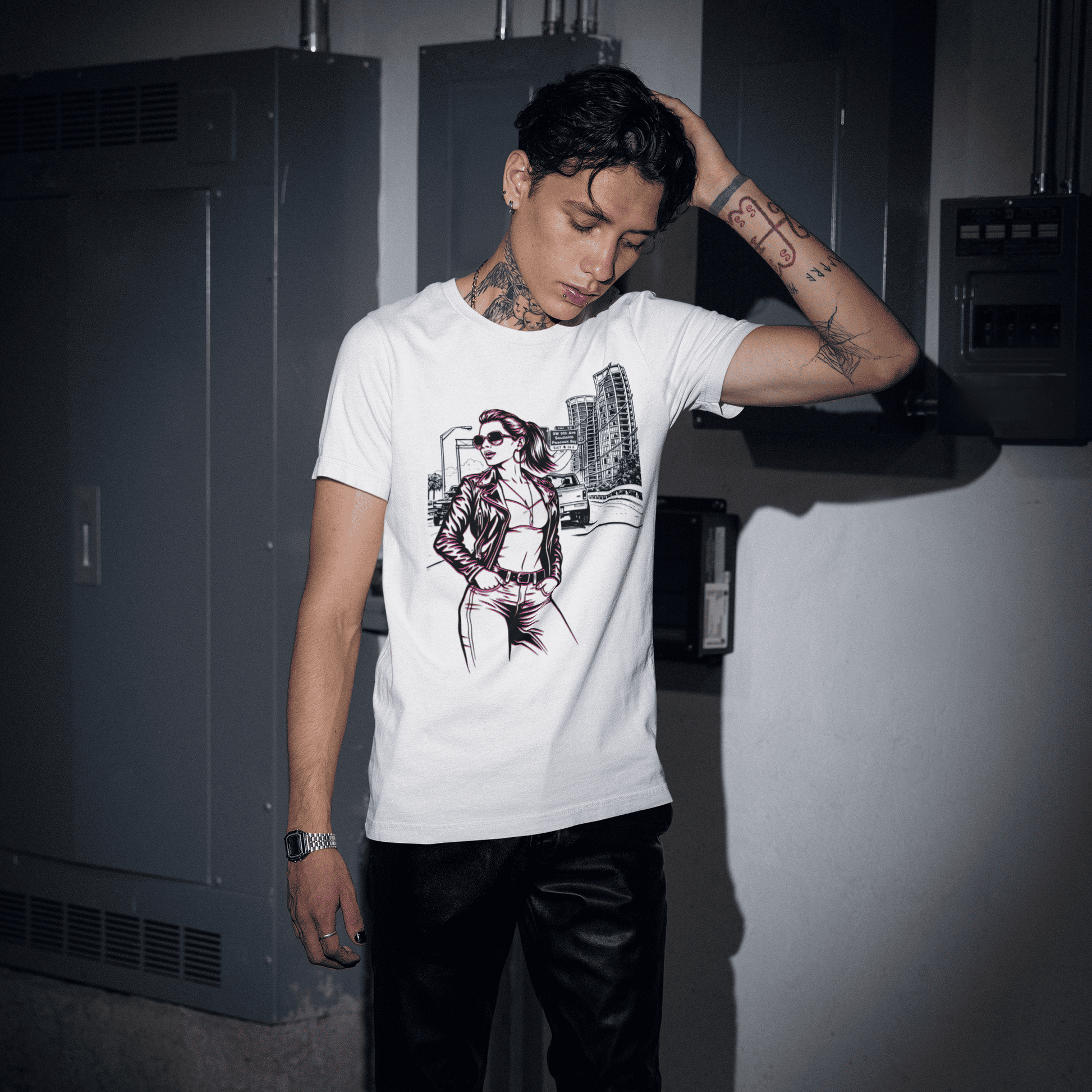 Person wearing a white t-shirt with a graphic design in a dimly lit room.