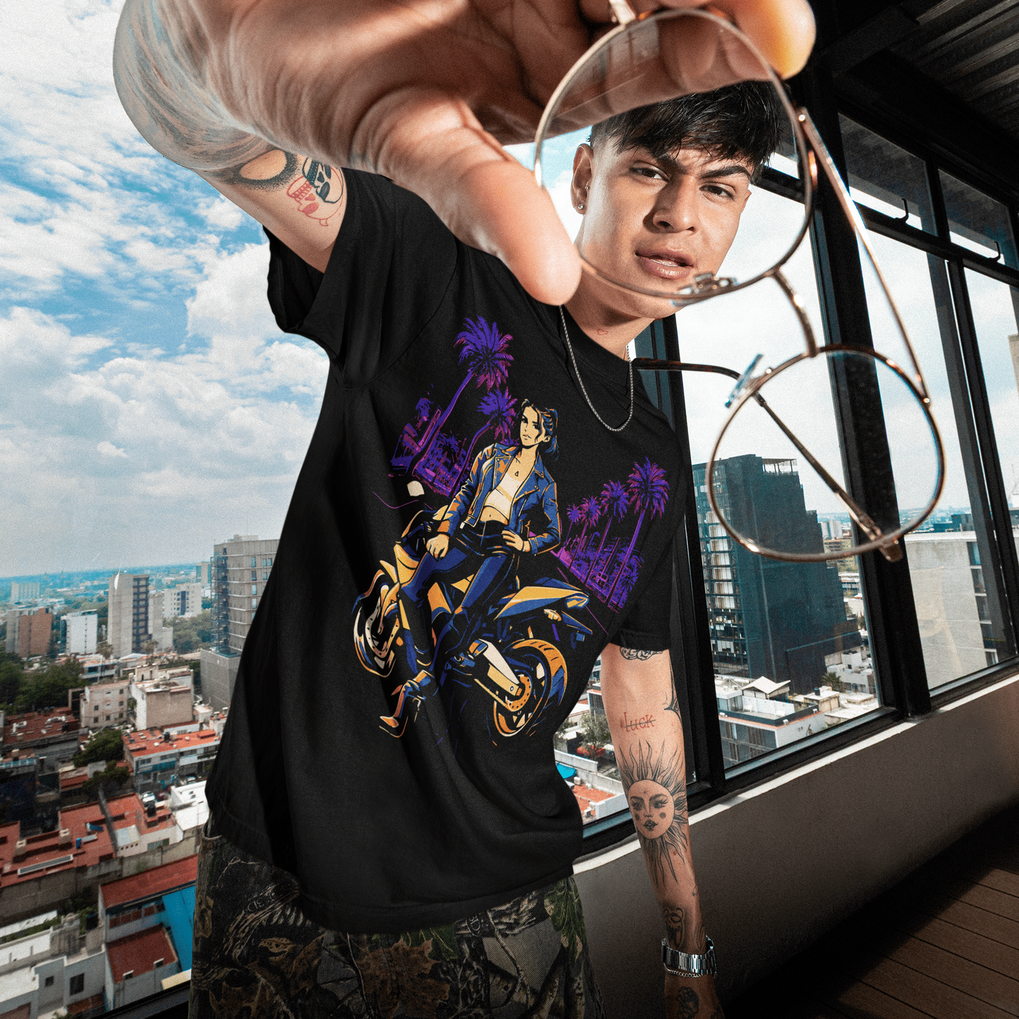 Person holding sunglasses with a cityscape view through large windows