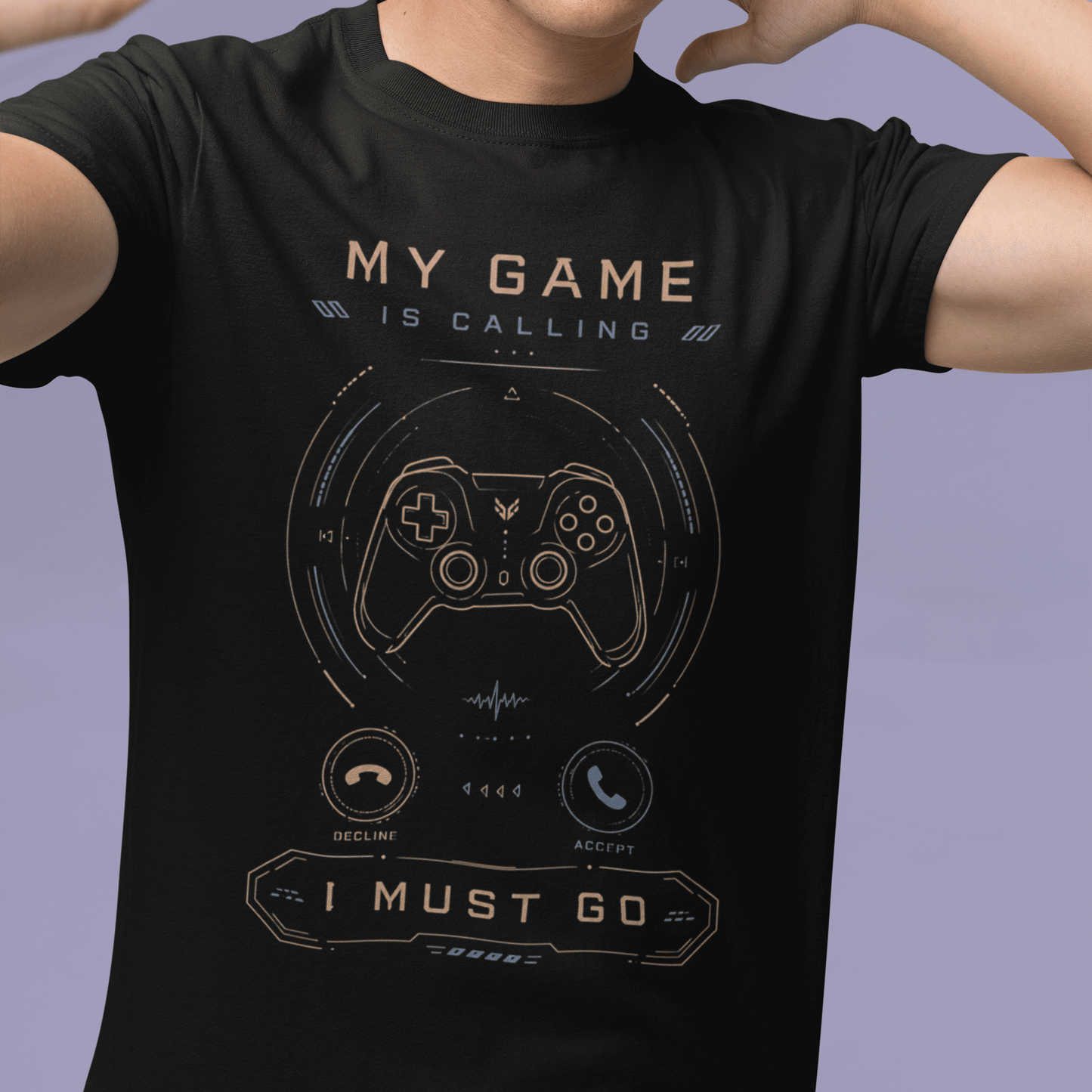Front view of My Game Is Calling T-Shirt – I Must Go Gamer Mood worn by a model with one hand raised