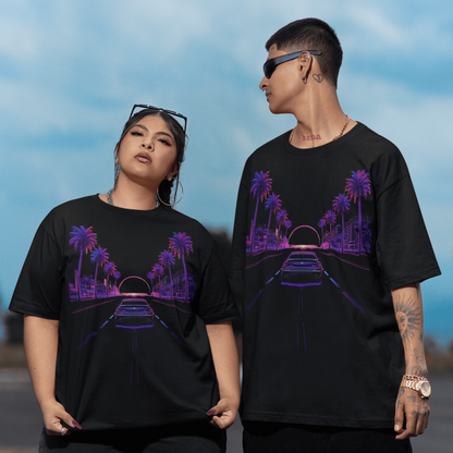 Two people wearing black t-shirts with a purple graphic design against a blue sky.