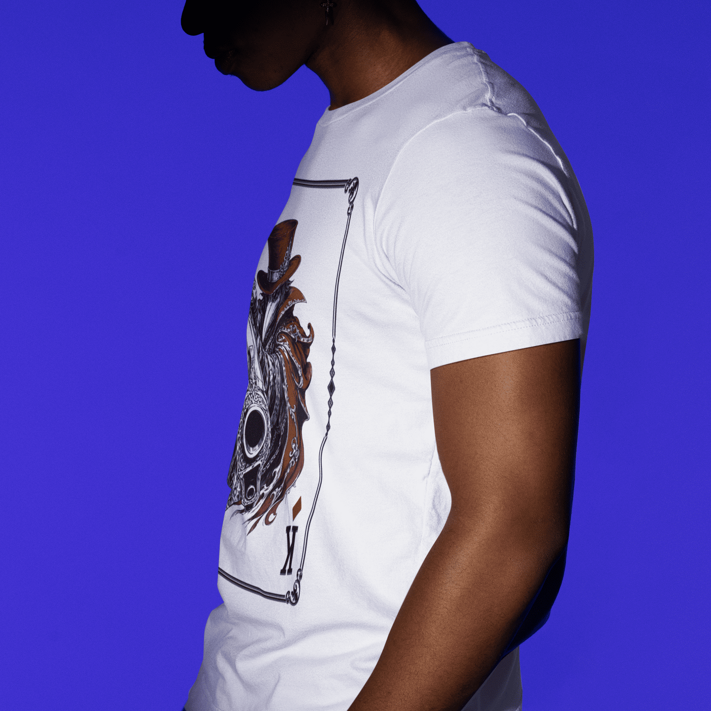 Side profile view of a model wearing the white Crowsworn King of Diamonds T-Shirt with the front artwork partially visible