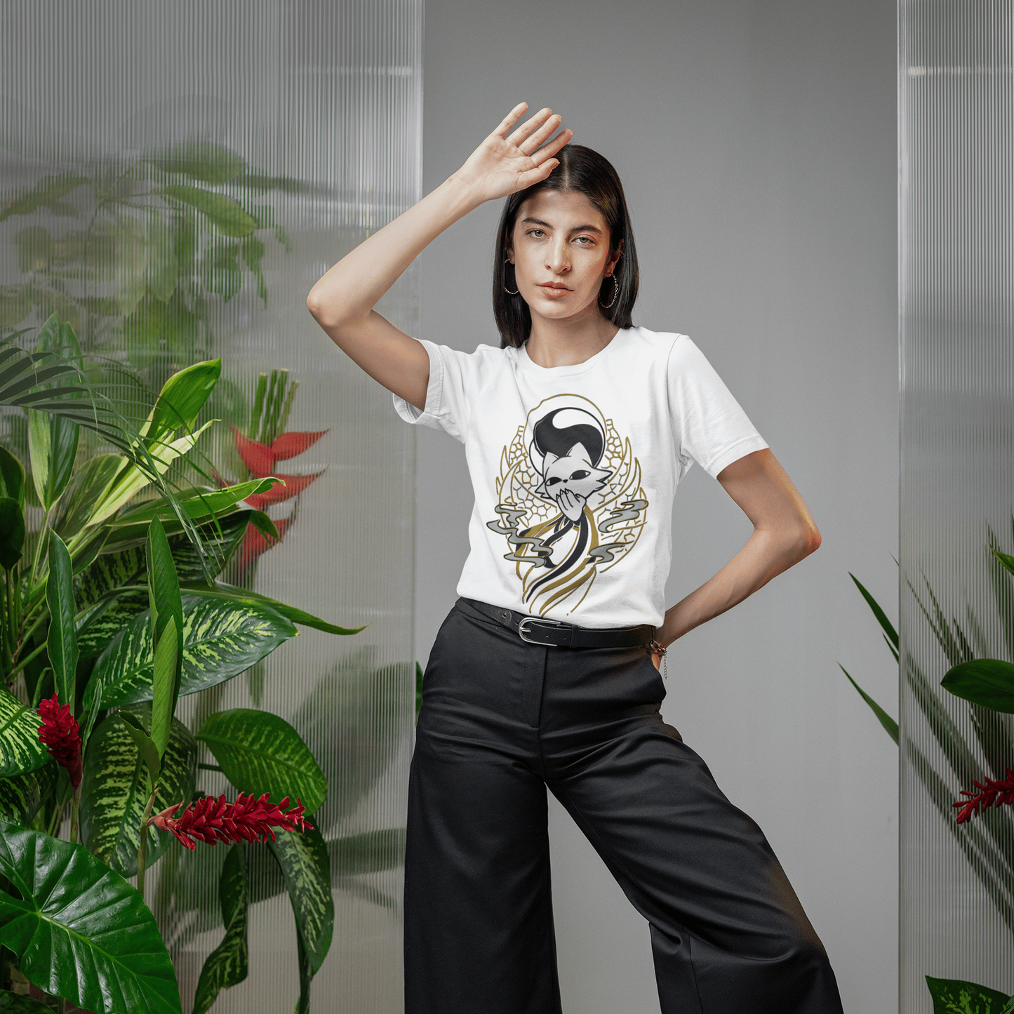 Female model wearing sunglasses and the white Nine Sols Yin Yang Tee – Balance Presence in a modern indoor lifestyle scene.