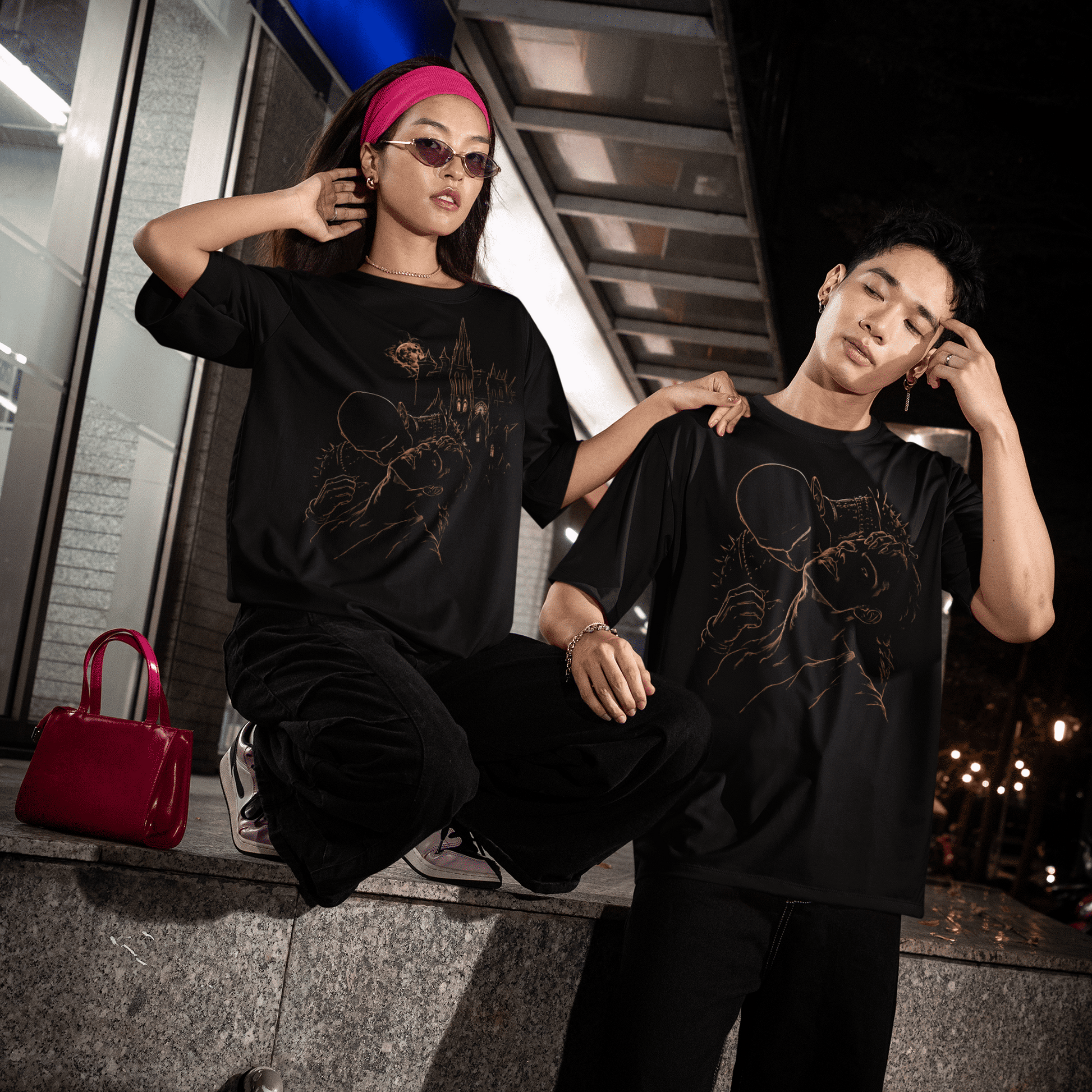 Night lifestyle view of two models wearing The Blood of Dawnwalker Sire Embrace T-Shirt and The Blood of Dawnwalker Sire Domain T-Shirt.