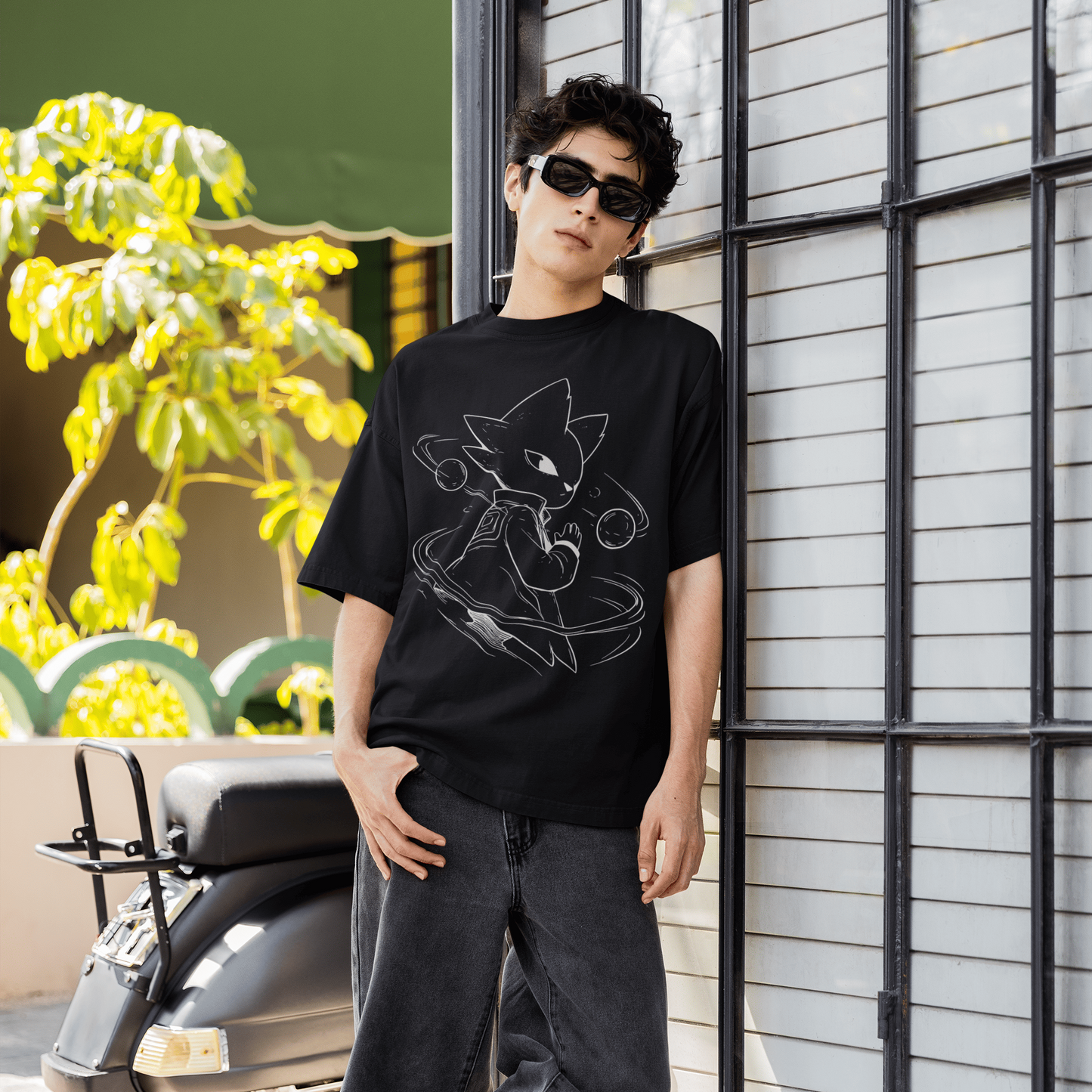 Full-body lifestyle shot of a model wearing the black Nine Sols Graphic Tee – Orbiting Focus Taopunk Motion near an industrial building.