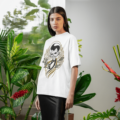Female model standing in a relaxed pose wearing the white Nine Sols Yin Yang Tee – Balance Presence indoors with tropical greenery.