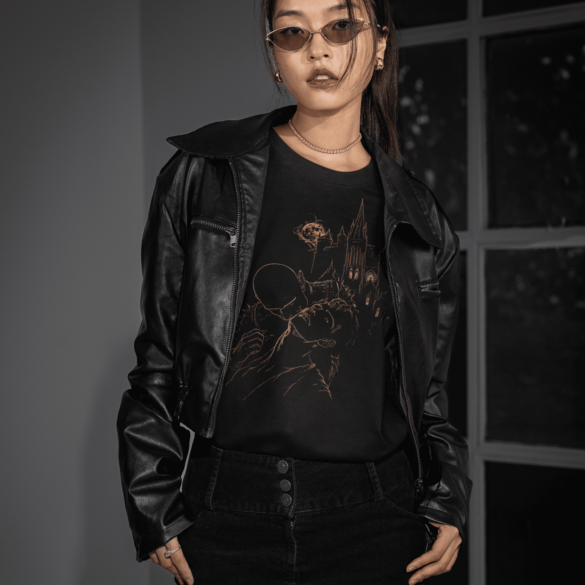 Front model view of The Blood of Dawnwalker Sire Domain T-Shirt with gold vampire artwork under a black leather jacket.