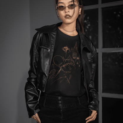 Front model view of The Blood of Dawnwalker Sire Domain T-Shirt with gold vampire artwork under a black leather jacket.