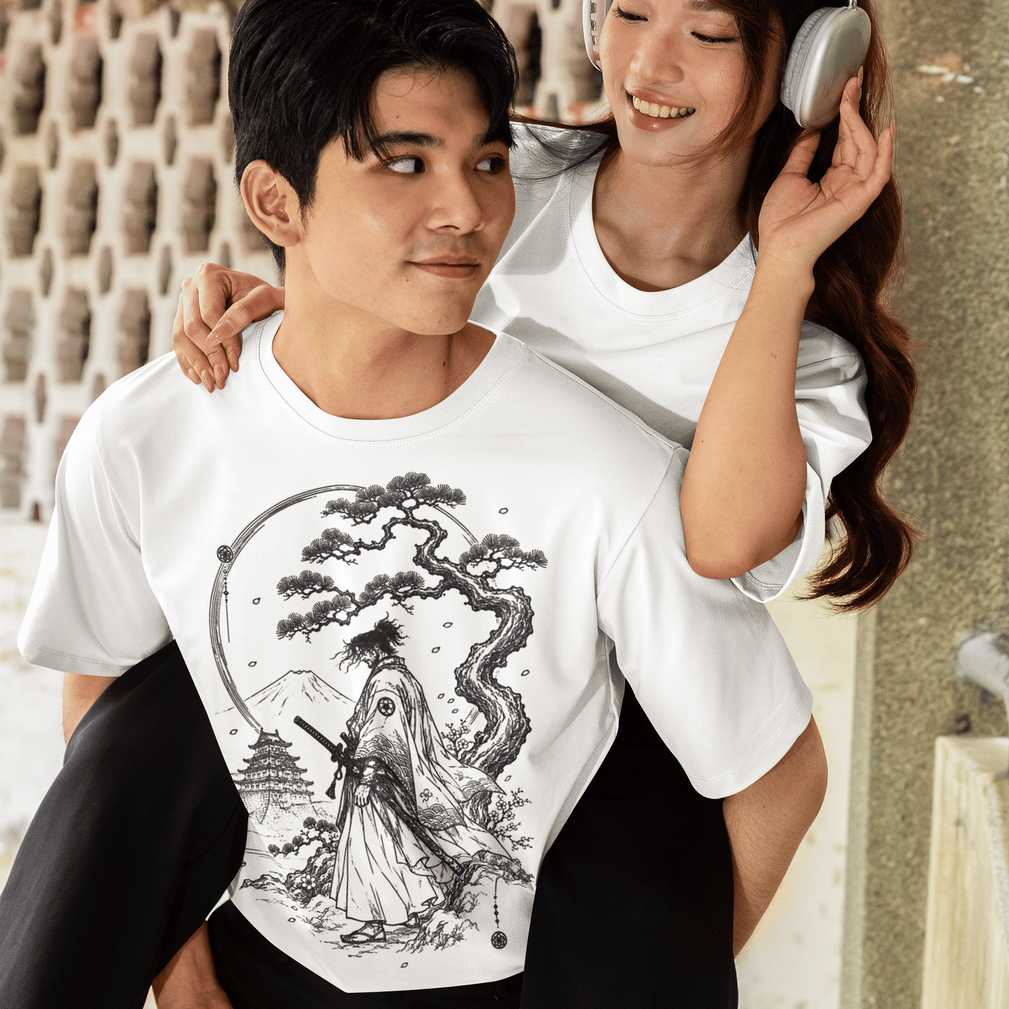 Male model with a companion wearing Fuji Samurai T-Shirt with quiet mountain warrior design in a casual outdoor setting.