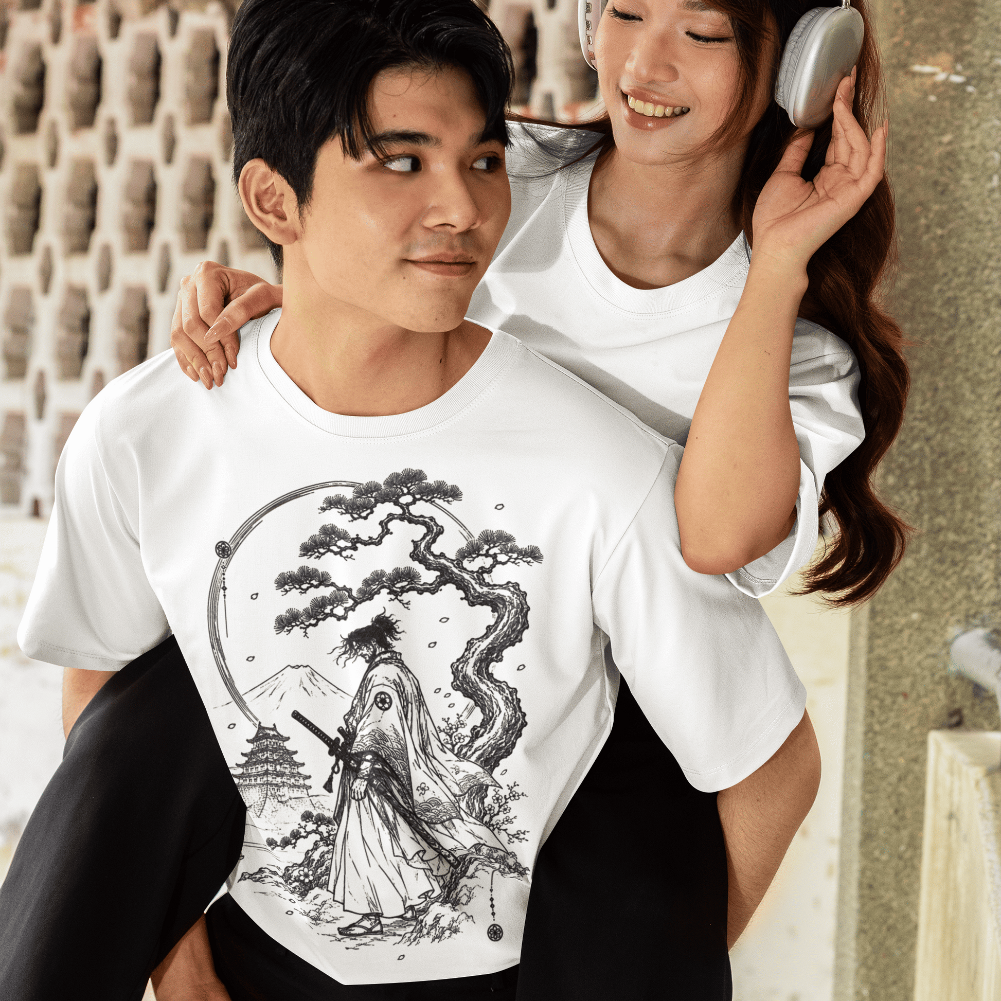 Male model with a companion wearing Fuji Samurai T-Shirt with quiet mountain warrior design in a casual outdoor setting.