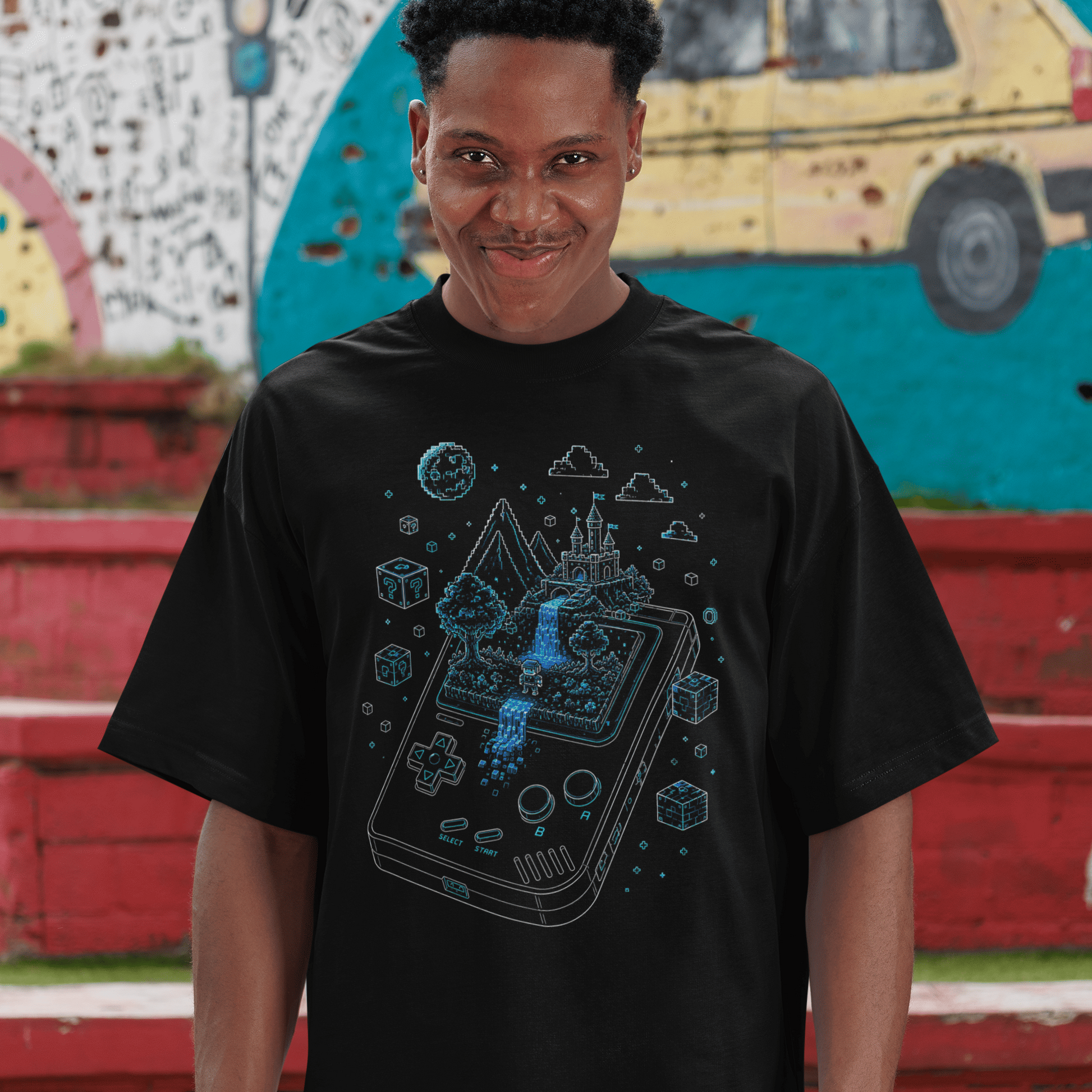 Full body view of Handheld Pixel World Gamer T-Shirt with Pixel Adventure Art worn by a model near colorful steps
