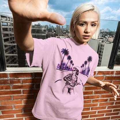 Person wearing a pink t-shirt with a graphic design on a rooftop with cityscape background