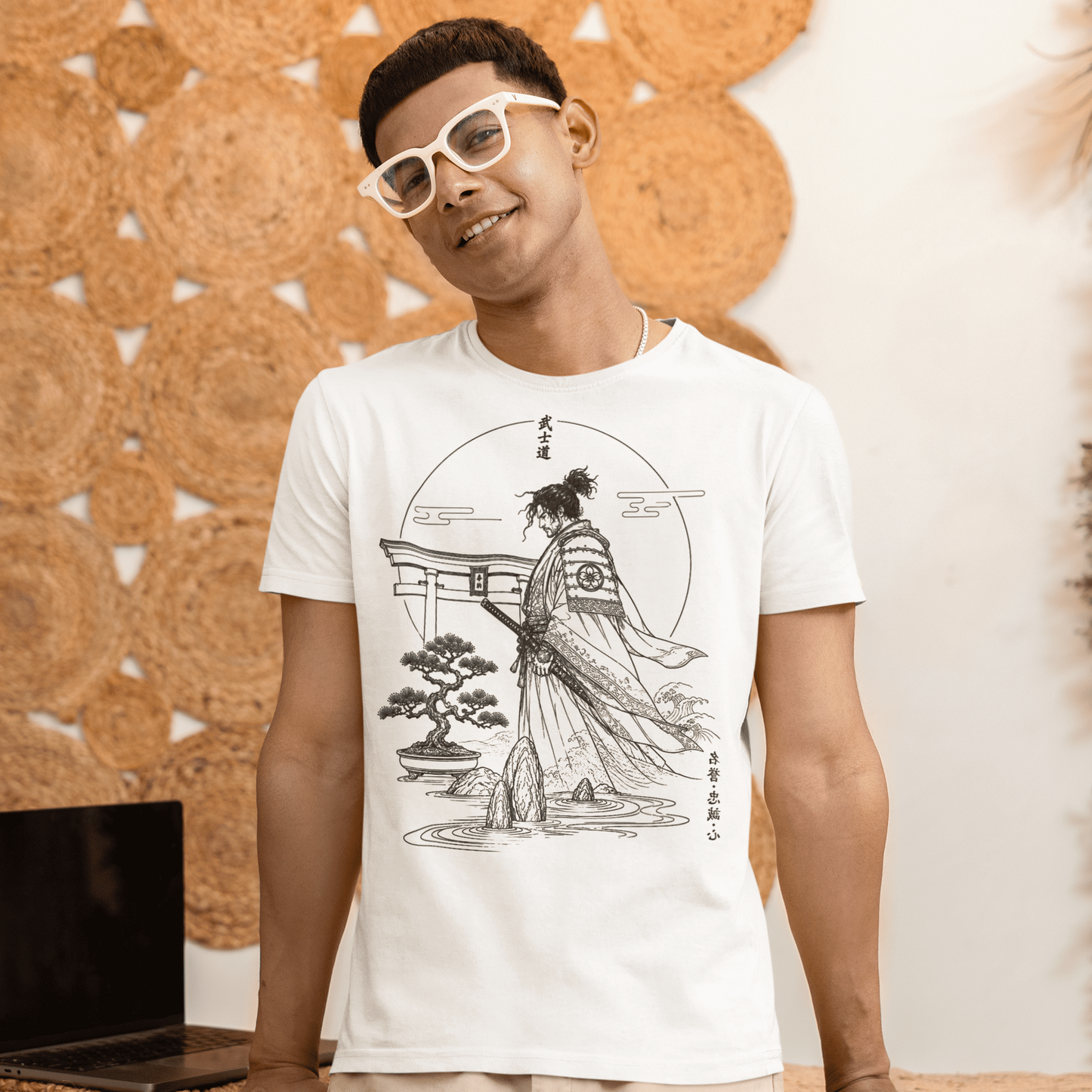 Male model standing in Bushido Samurai T-Shirt with quiet warrior garden design in a warm indoor lifestyle scene.