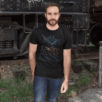 Man wearing a black t-shirt with a graphic design standing in front of an old train.