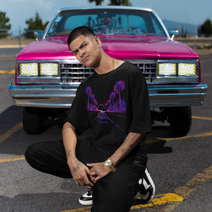 Grand Theft Auto VI Neon Horizon Drive Tee worn by man posing in front of pink truck with palm trees at night