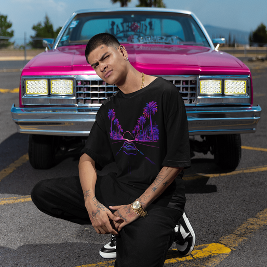 Grand Theft Auto VI Neon Horizon Drive Tee worn by man posing in front of pink truck with palm trees at night