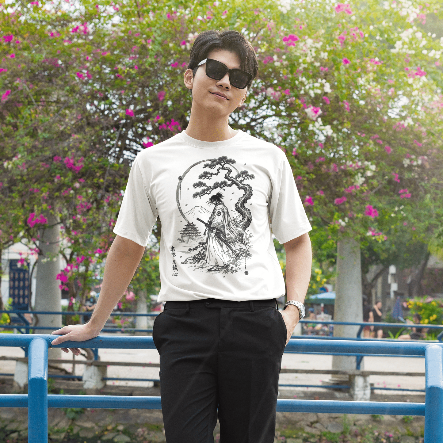 Male model leaning on a railing in Fuji Samurai T-Shirt with quiet mountain warrior design and casual styling.