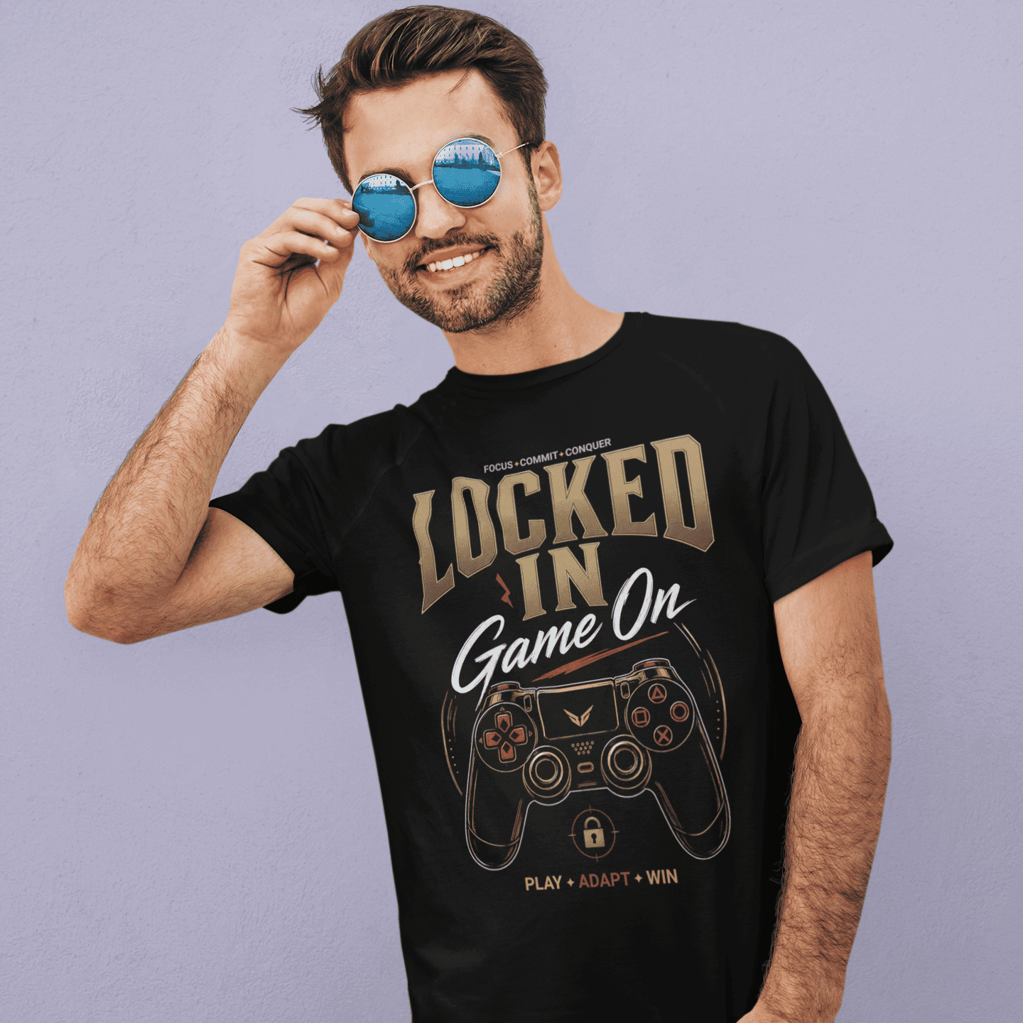 Male gamer adjusting his sunglasses in Locked In Gamer T-Shirt with focus mode artwork on a purple background.
