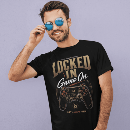 Male gamer adjusting his sunglasses in Locked In Gamer T-Shirt with focus mode artwork on a purple background.