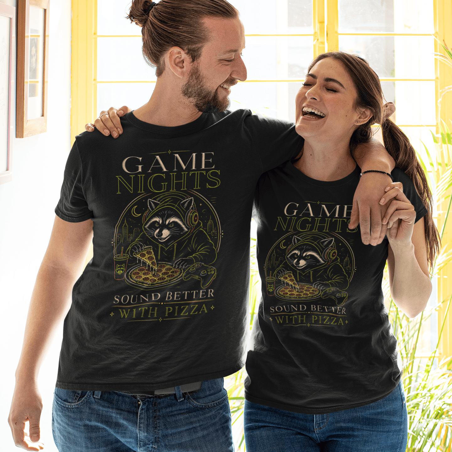 Couple view of Game Nights Sound Better with Pizza T-Shirt worn by two models indoors