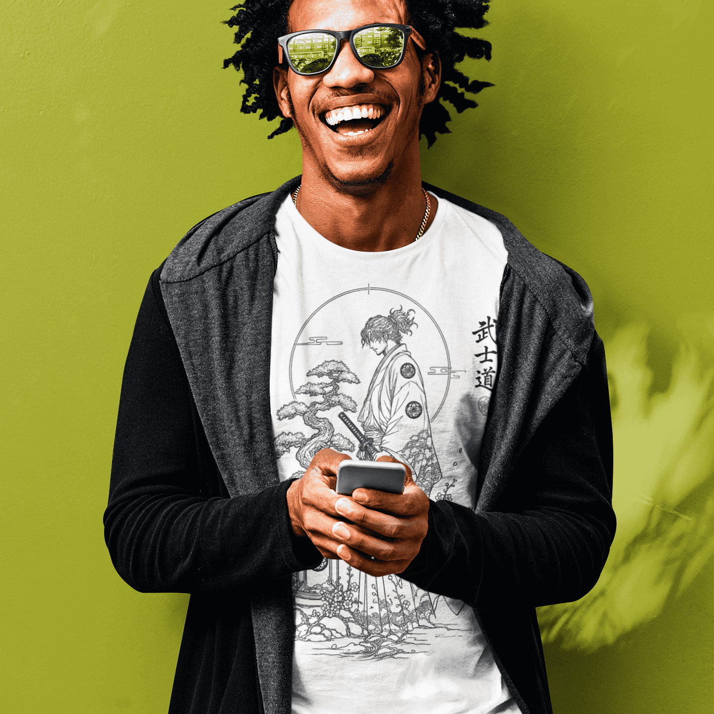 Male model wearing sunglasses and Bonsai Samurai T-Shirt with Bushido warrior design against a bright green wall.