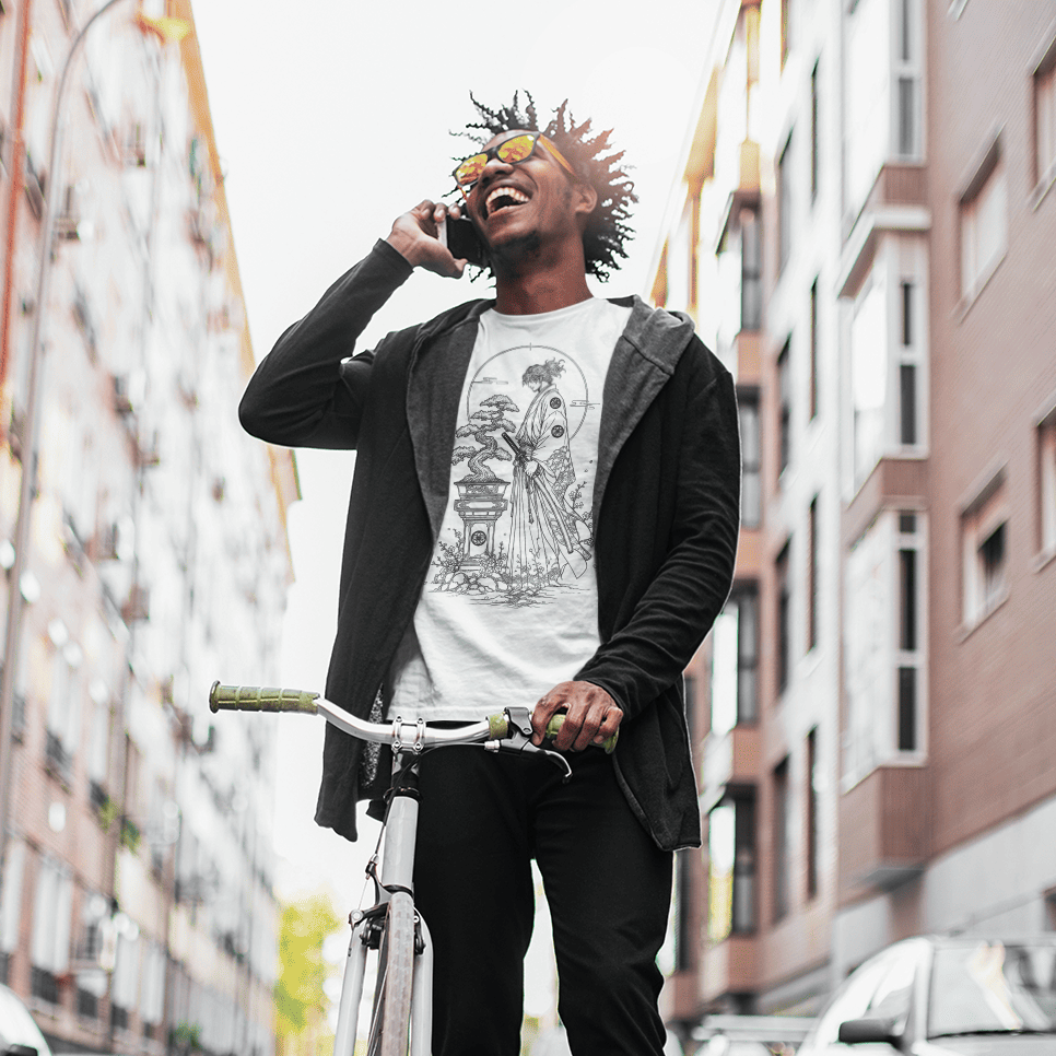Male model relaxing beside a bicycle in Bonsai Samurai T-Shirt with quiet warrior design in an urban setting.
