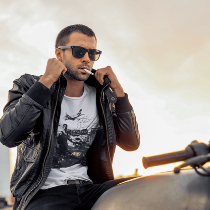 Man sitting on a motorcycle wearing sunglasses and a leather jacket with a blurred background