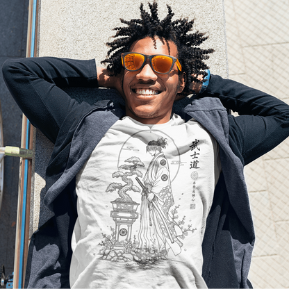 Close-up of smiling male model in Bonsai Samurai T-Shirt with Bushido warrior artwork beside a white brick wall.
