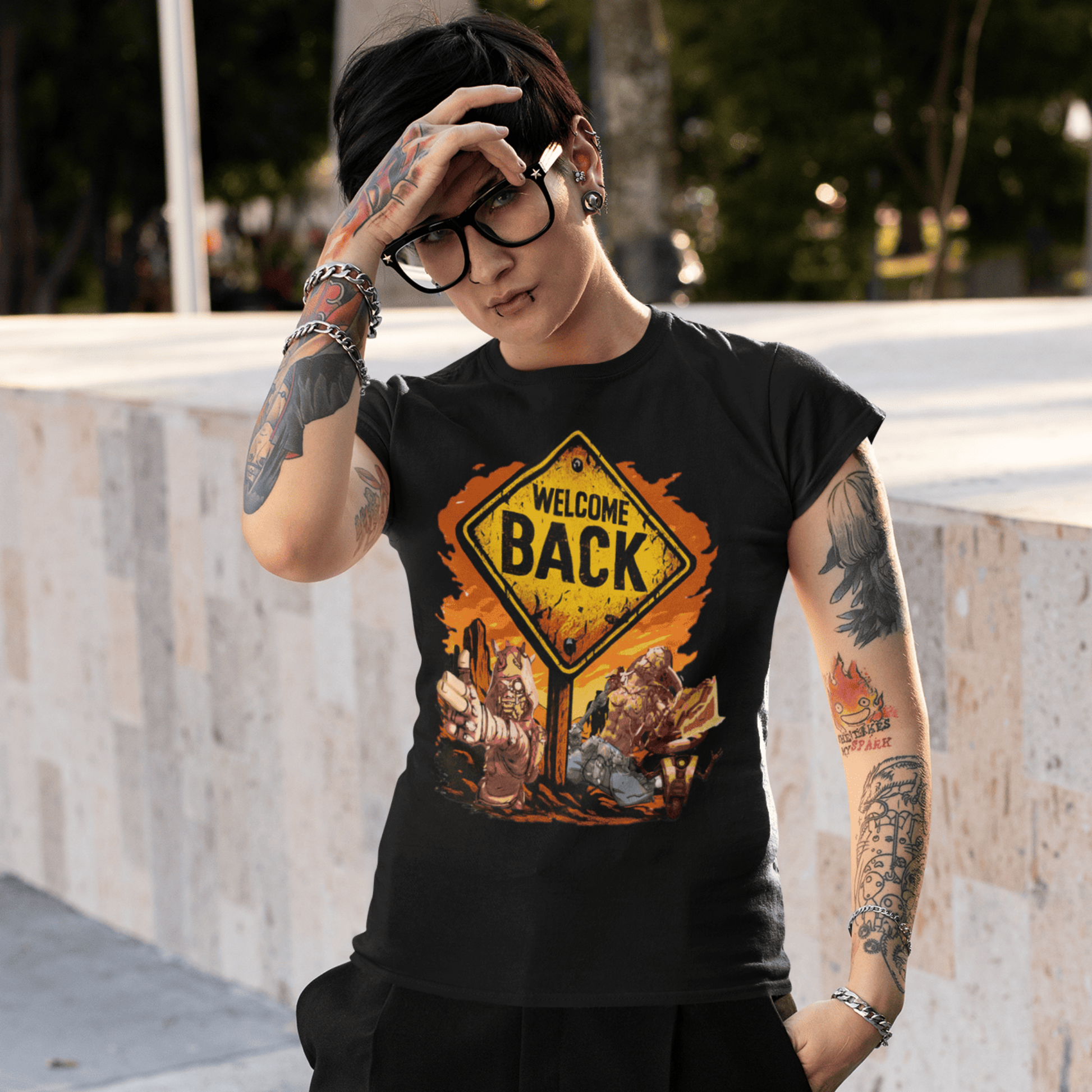 Person wearing a black t-shirt with a 'Welcome Back' graphic design outdoors.