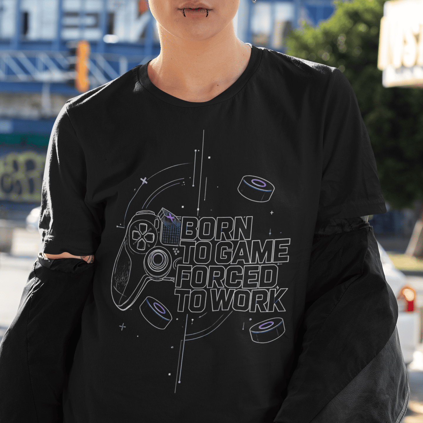 Close front view of Born to Game Forced to Work Gamer T-Shirt worn by a model in an urban setting
