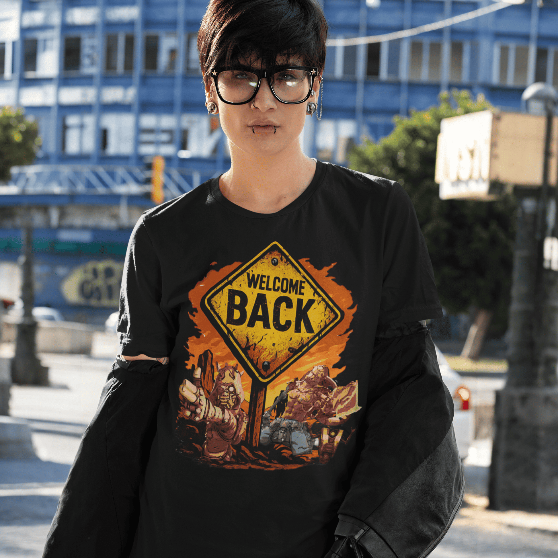 Person wearing a black t-shirt with a 'Welcome Back' graphic design outdoors.