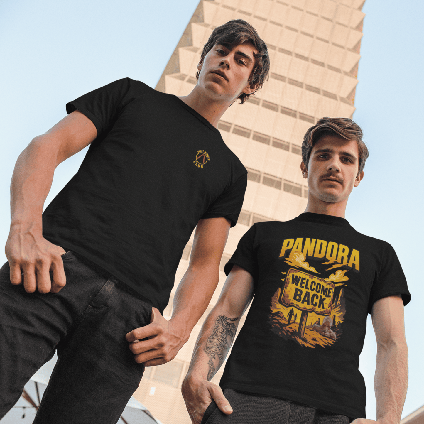 Two men wearing black t-shirts with graphic designs in an urban setting
