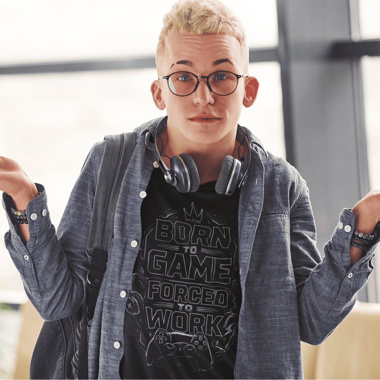 Front view of Born to Game Forced to Work T-Shirt – Headset Gamer Mode worn with headphones and shrug pose