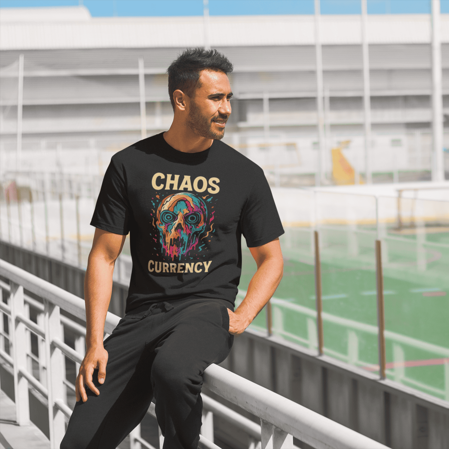 Man wearing a black t-shirt with colorful graphic and text, standing outdoors.