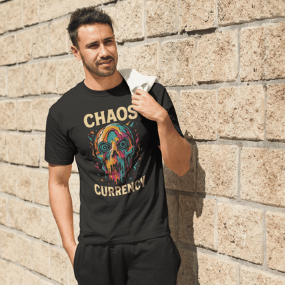 Man wearing a black t-shirt with colorful graphic and text, standing against a stone wall.